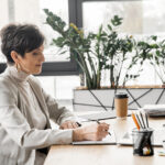 photo of productive business owner sitting at a desk