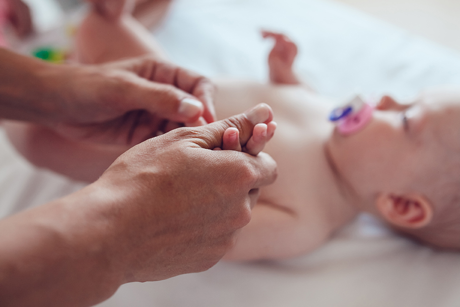 Woman doing exercises and massage the baby