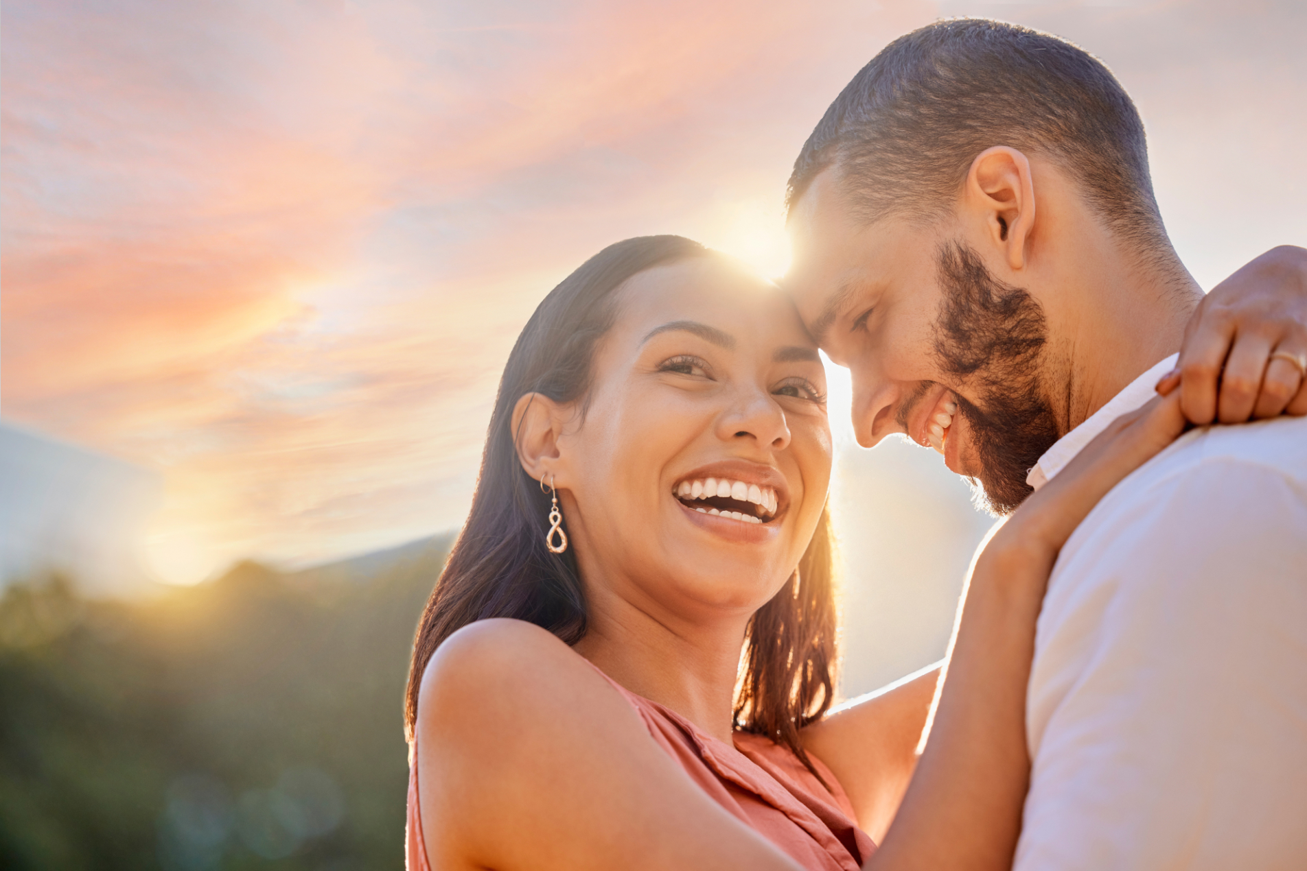 Sunset, romance and love with a couple hugging outdoor while happy dating in nature together. Sky, mockup and date with a young man and woman embracing while romantic bonding outside in summer couples preconception photo