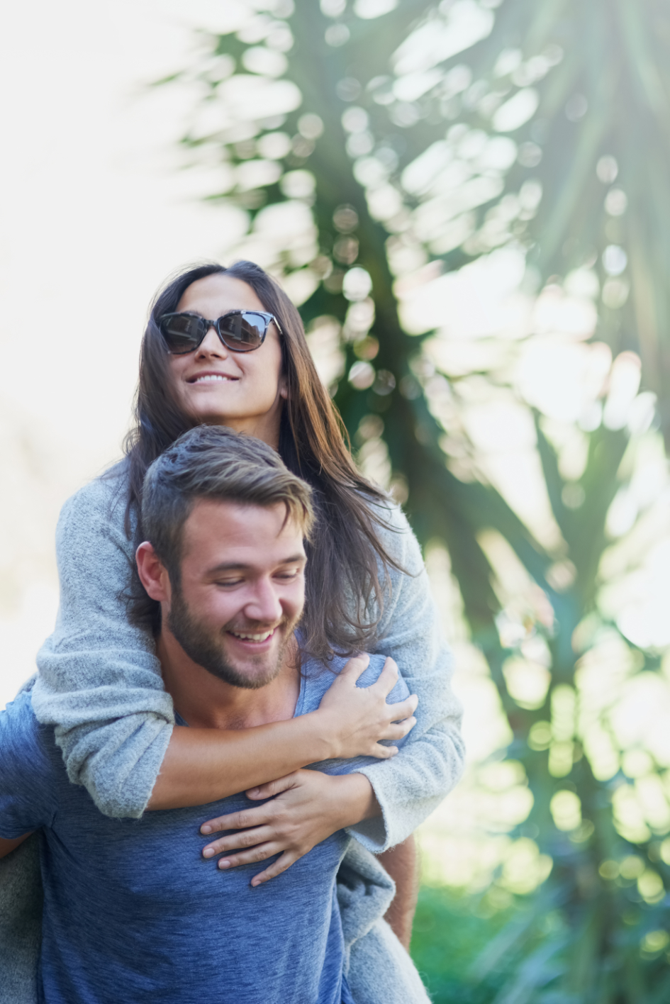 Fun and in love. Shot of a young man giving his girlfriend a piggyback while enjoying a day together outside. photo of couple contemplating having a baby