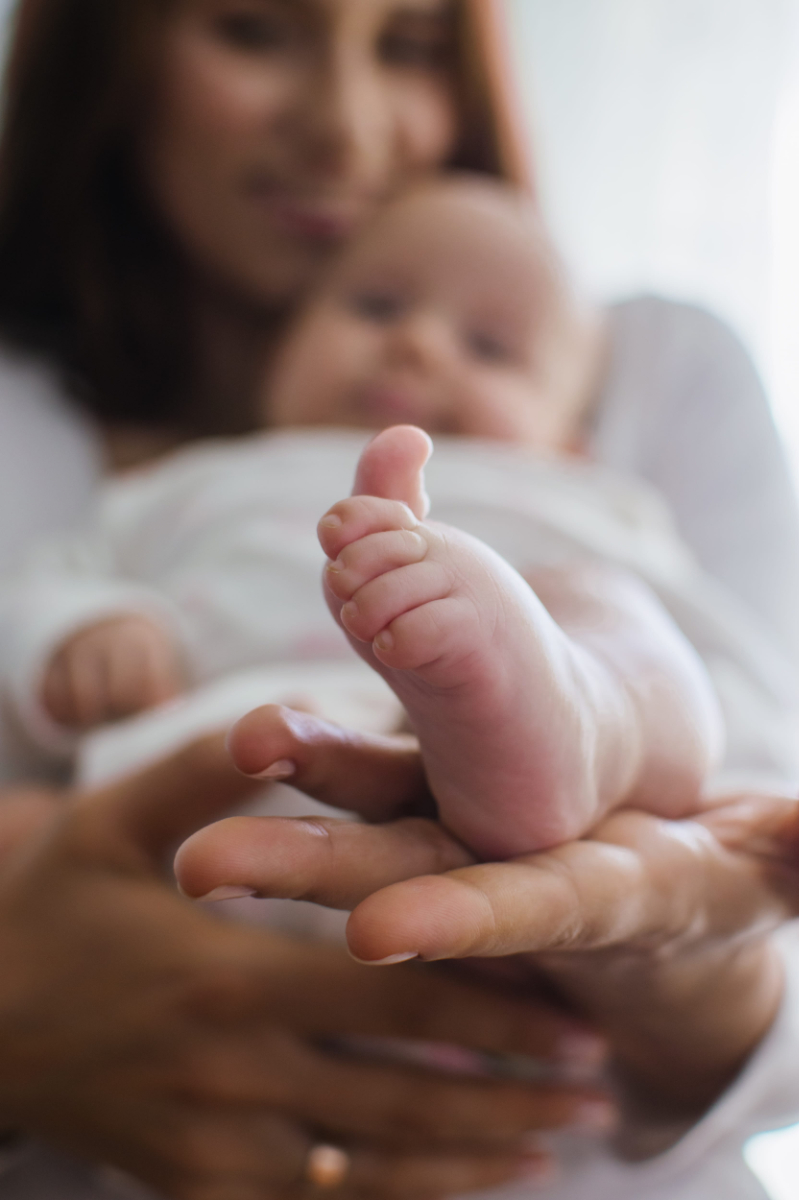 infant Baby feet in parent hands