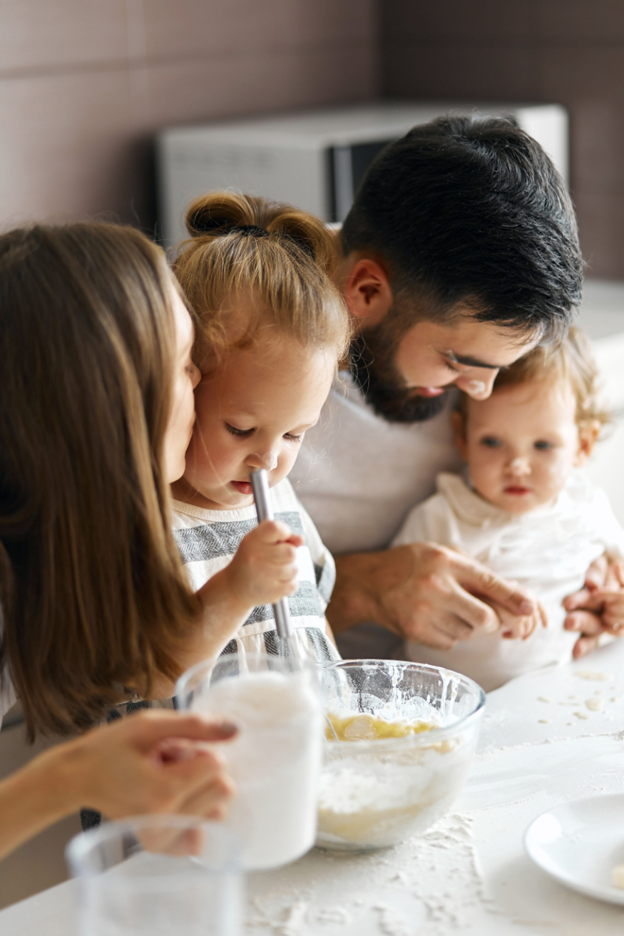 father and mother giving advice how to cook pancakes, close up cropped photo busy parents photo
