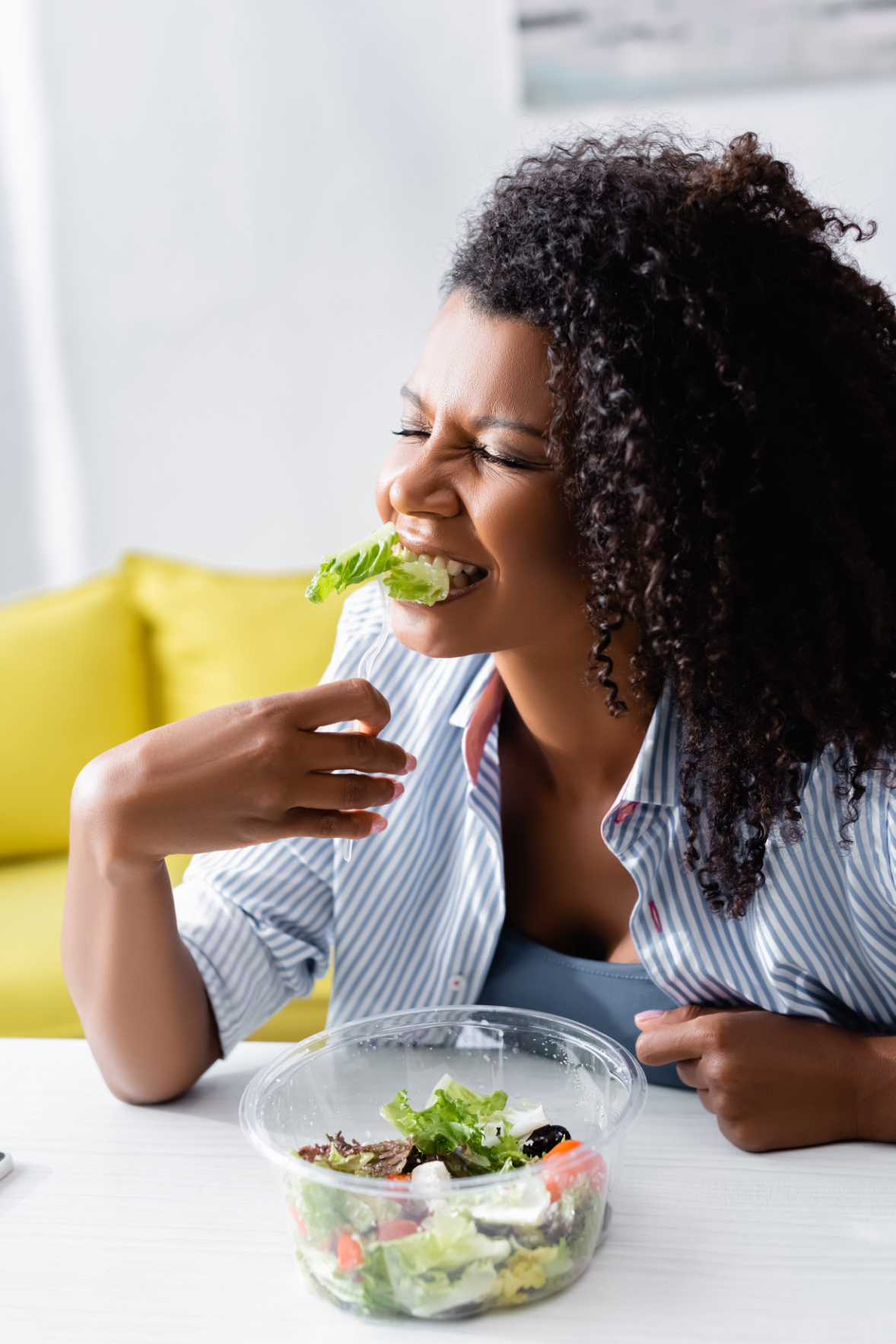 African american woman eating takeaway salad at home Happy Healthy dinner photo
