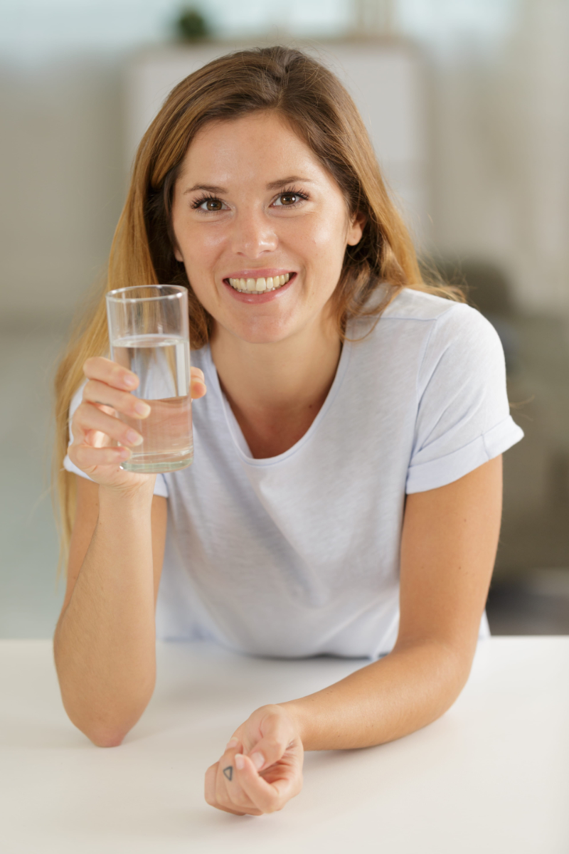 beautiful woman drinking water Photo of taking a pill to fix pain