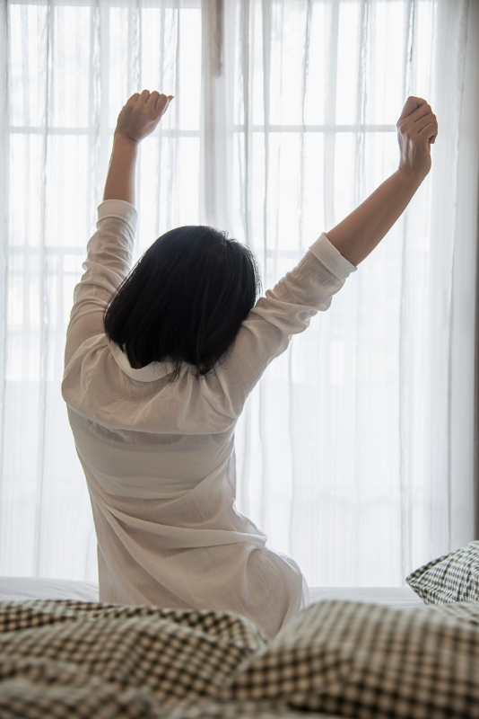 Lady wake up stretch oneself lazily for fresh morning - health care concept morning stiffness adult
